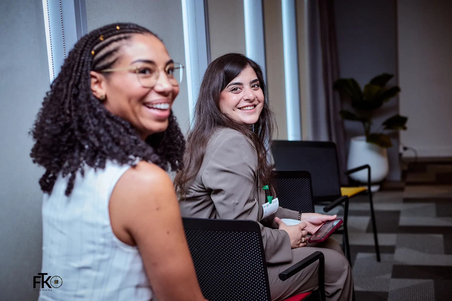 Two attendees smiling at the AI for Good Hackathon, Accra, 2026